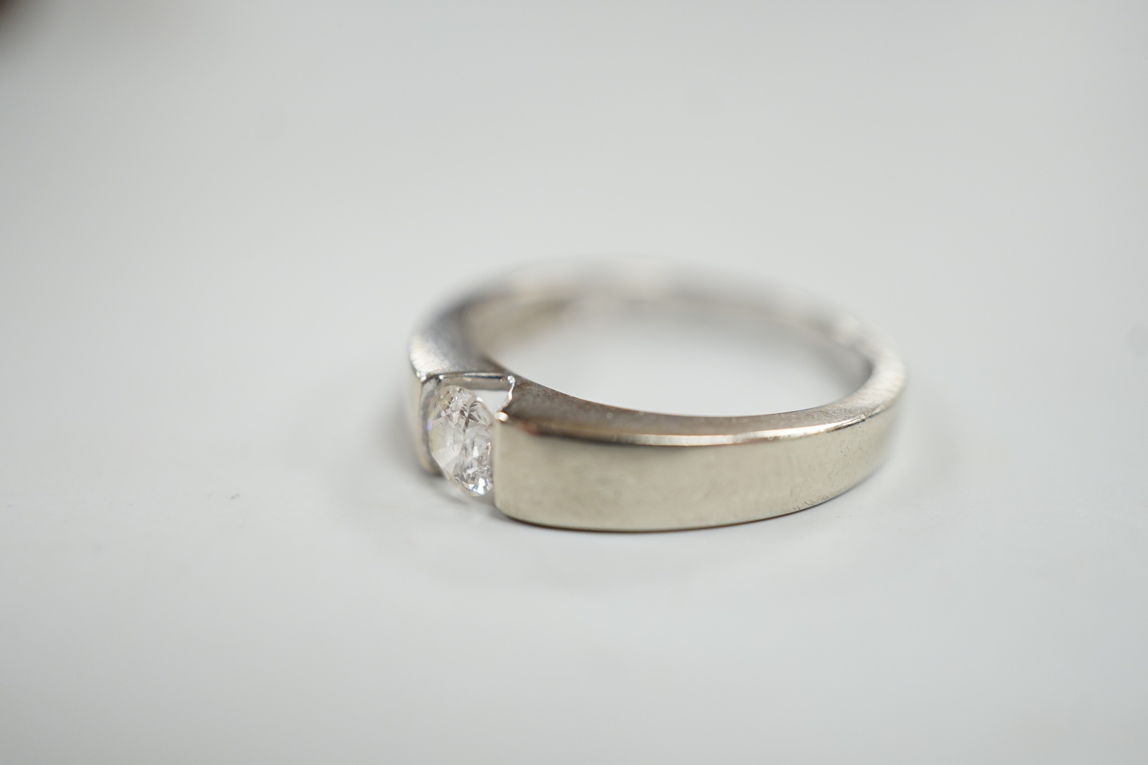 A modern 9ct white gold and solitaire diamond set ring, the stone weighing 0.34ct, size M/N, gross weight 3.2 grams.
